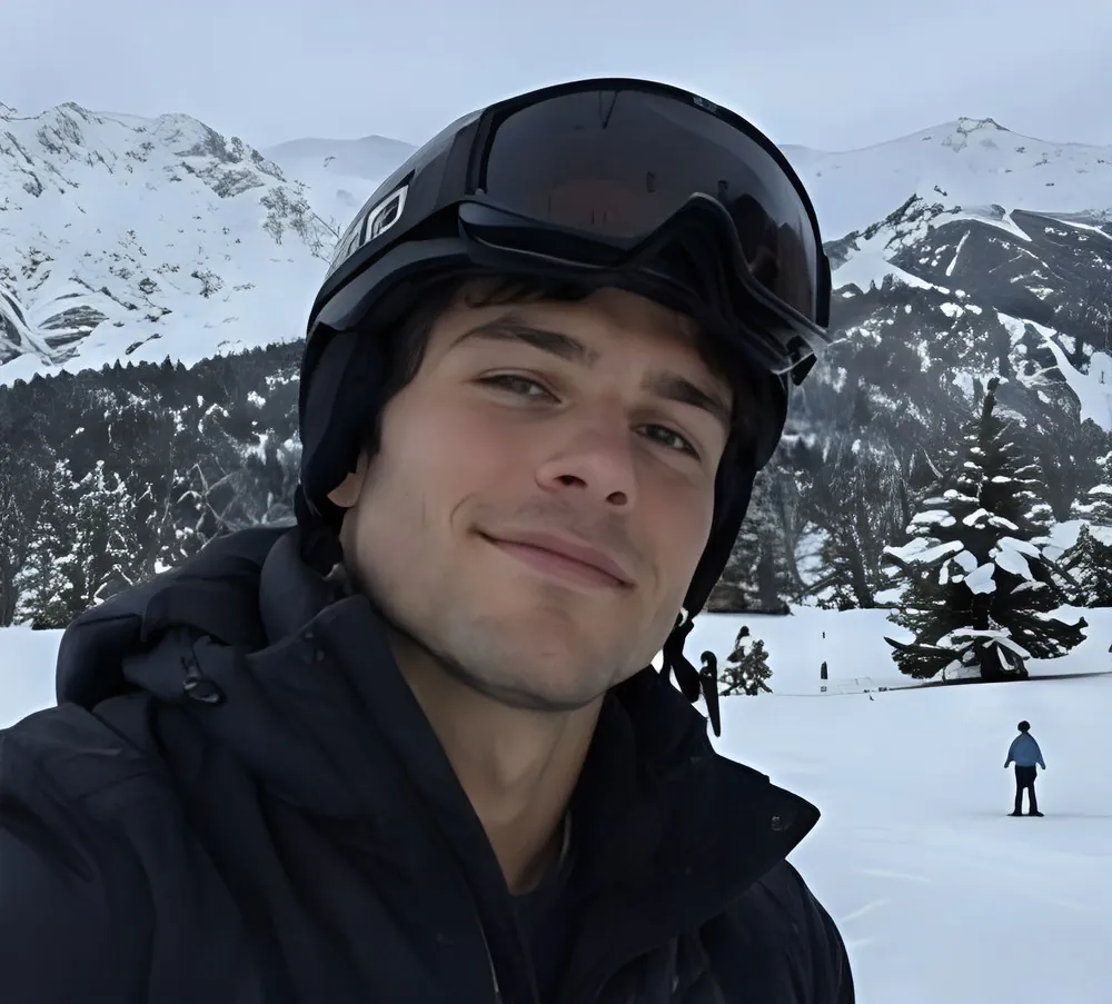 Terra Chad skiing, helmet and goggles, snowy mountains