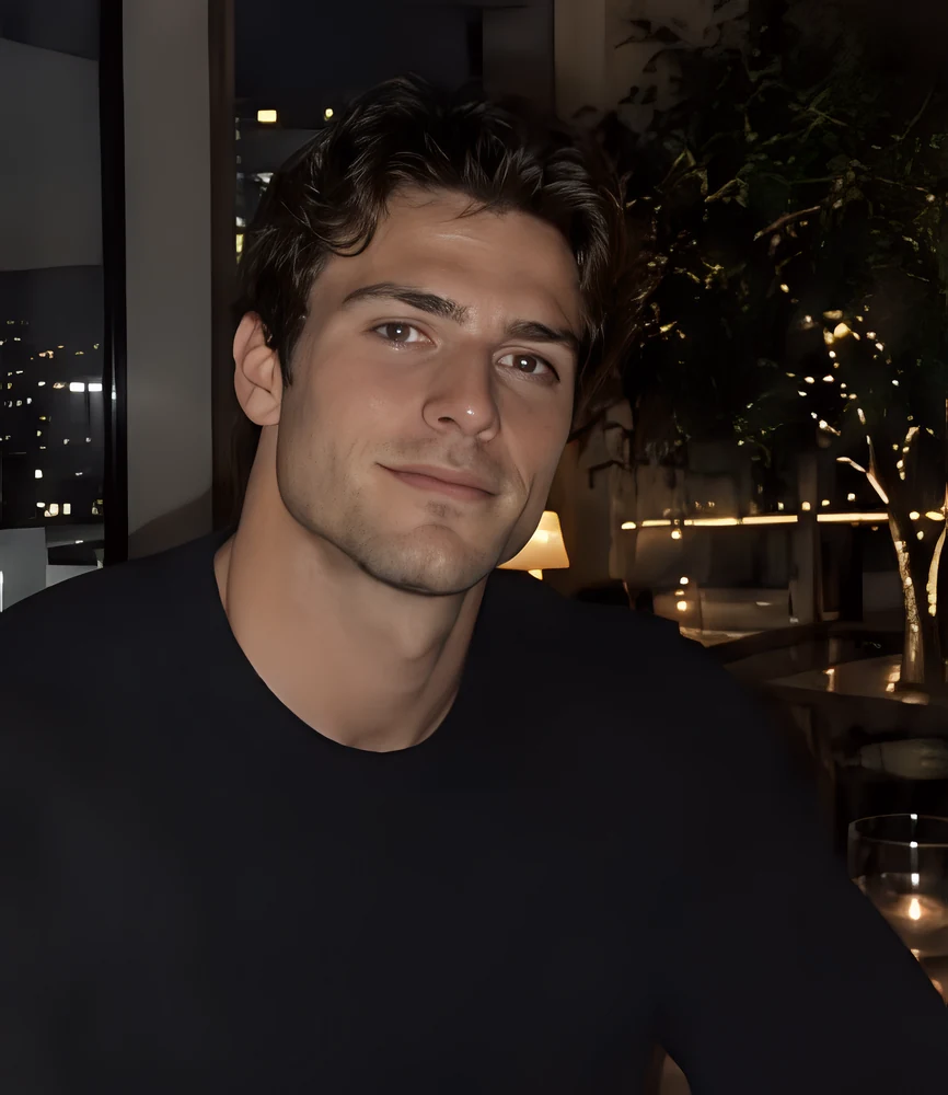 Terra Chad at dinner, black sweater, city lights behind him