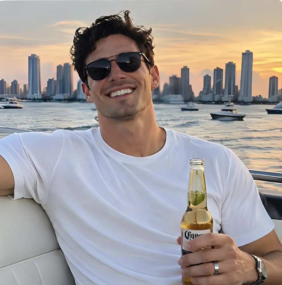 Terra Chad on a boat at sunset, beer in hand, wedding ring on